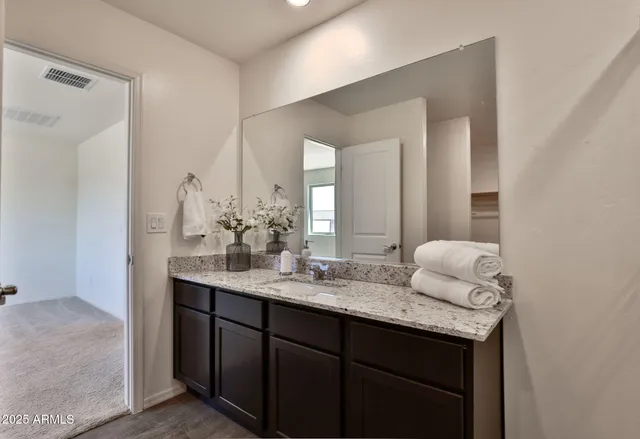 a bathroom with a shower sink and mirror