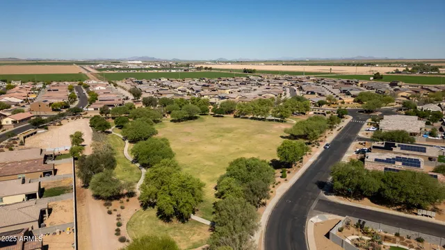 a front view of a house with a yard and a car park