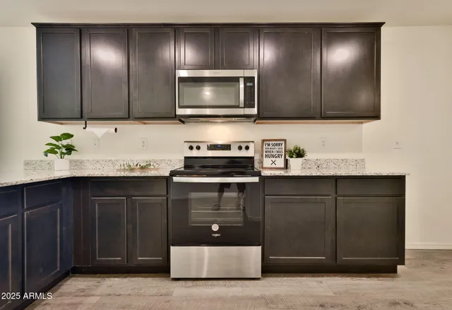 a kitchen with sink cabinets and stainless steel appliances