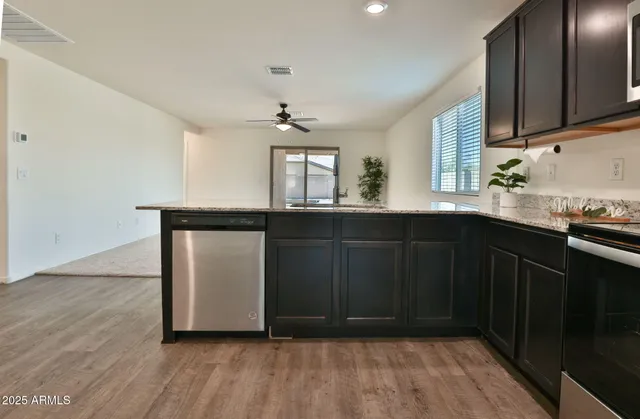 a kitchen with granite countertop a sink and cabinets