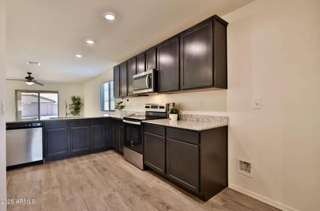 a kitchen with granite countertop stainless steel appliances and sink