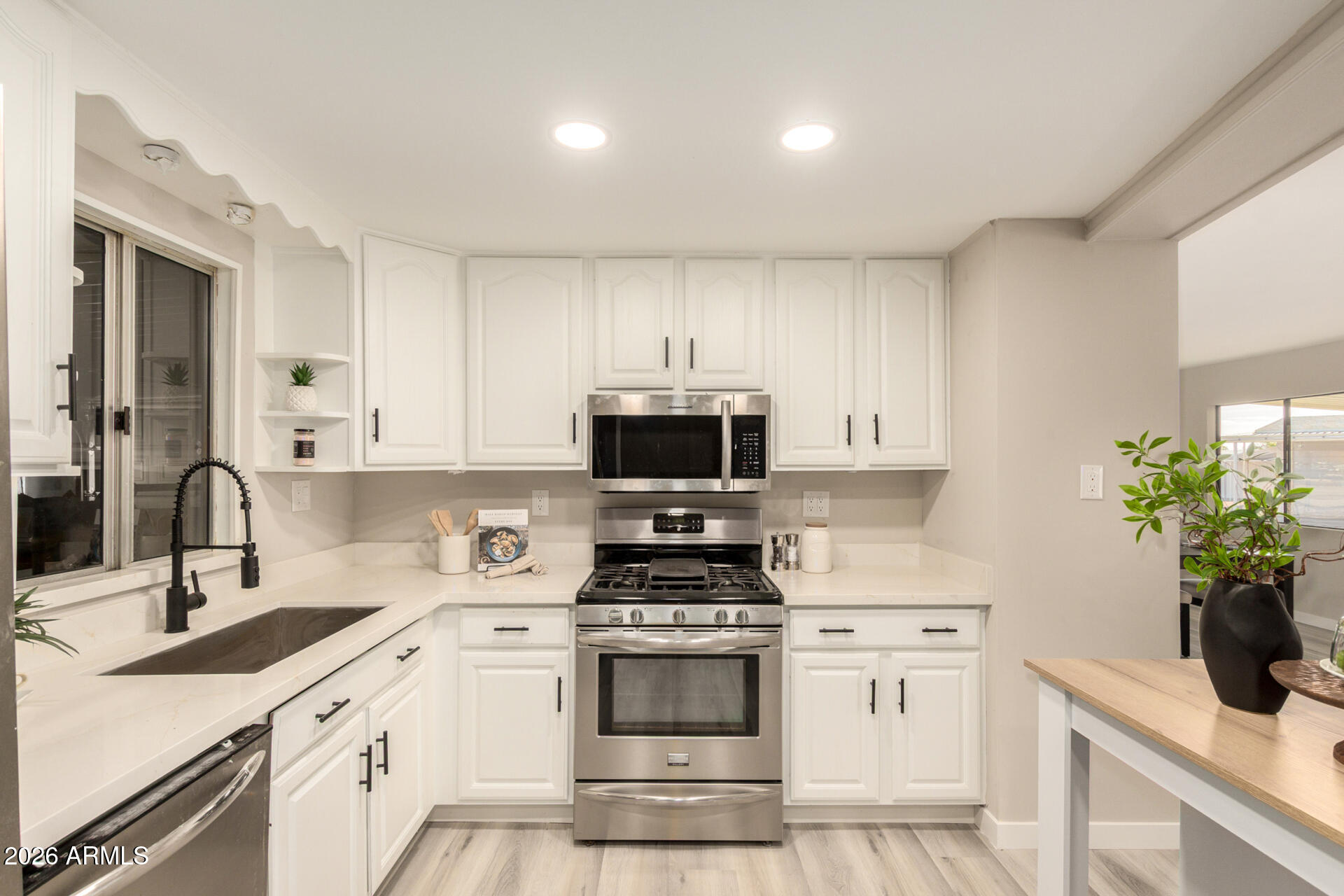 422 South 80th Way Mesa, AZ 85208 - Photo 16 of 28 a kitchen with a sink stove and cabinets