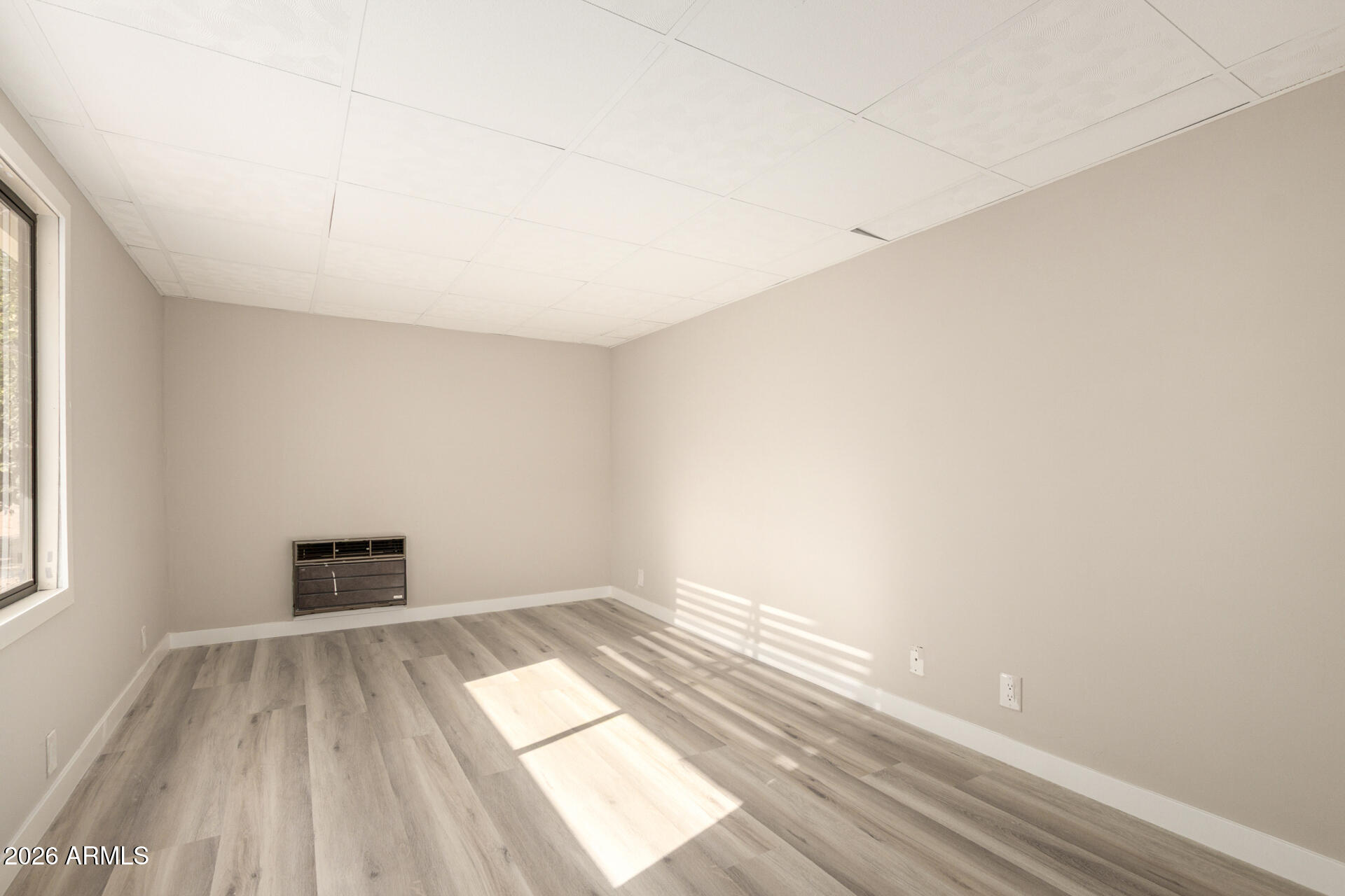 422 South 80th Way Mesa, AZ 85208 - Photo 25 of 28 an empty room with wooden floor and windows