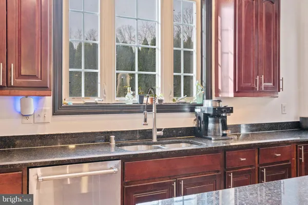 a kitchen with granite countertop a sink and a window