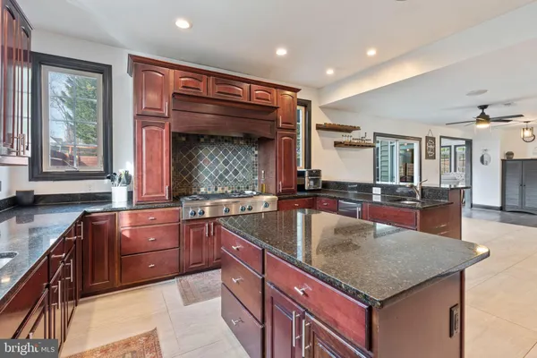 a kitchen with large cabinets a sink and a window