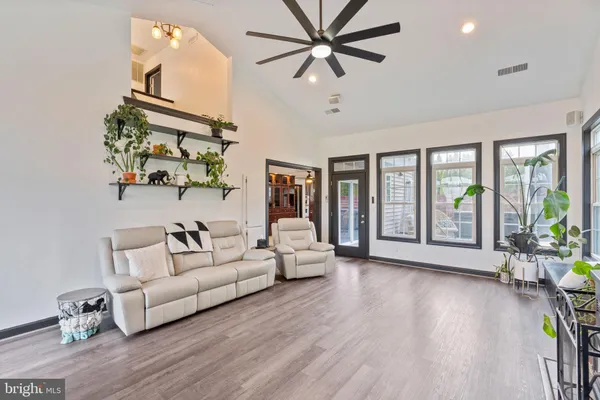 a living room with furniture and large windows