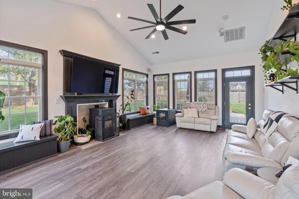 a living room with furniture a fireplace and a flat screen tv