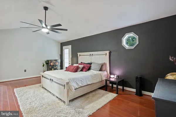 a bedroom with a bed and a lamp