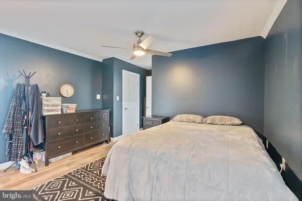 a spacious bedroom with a bed and a dresser