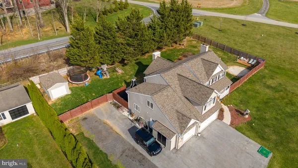 an aerial view of a house with a yard basket ball court and outdoor seating