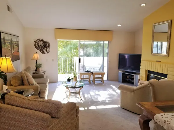a living room with fireplace furniture and a flat screen tv