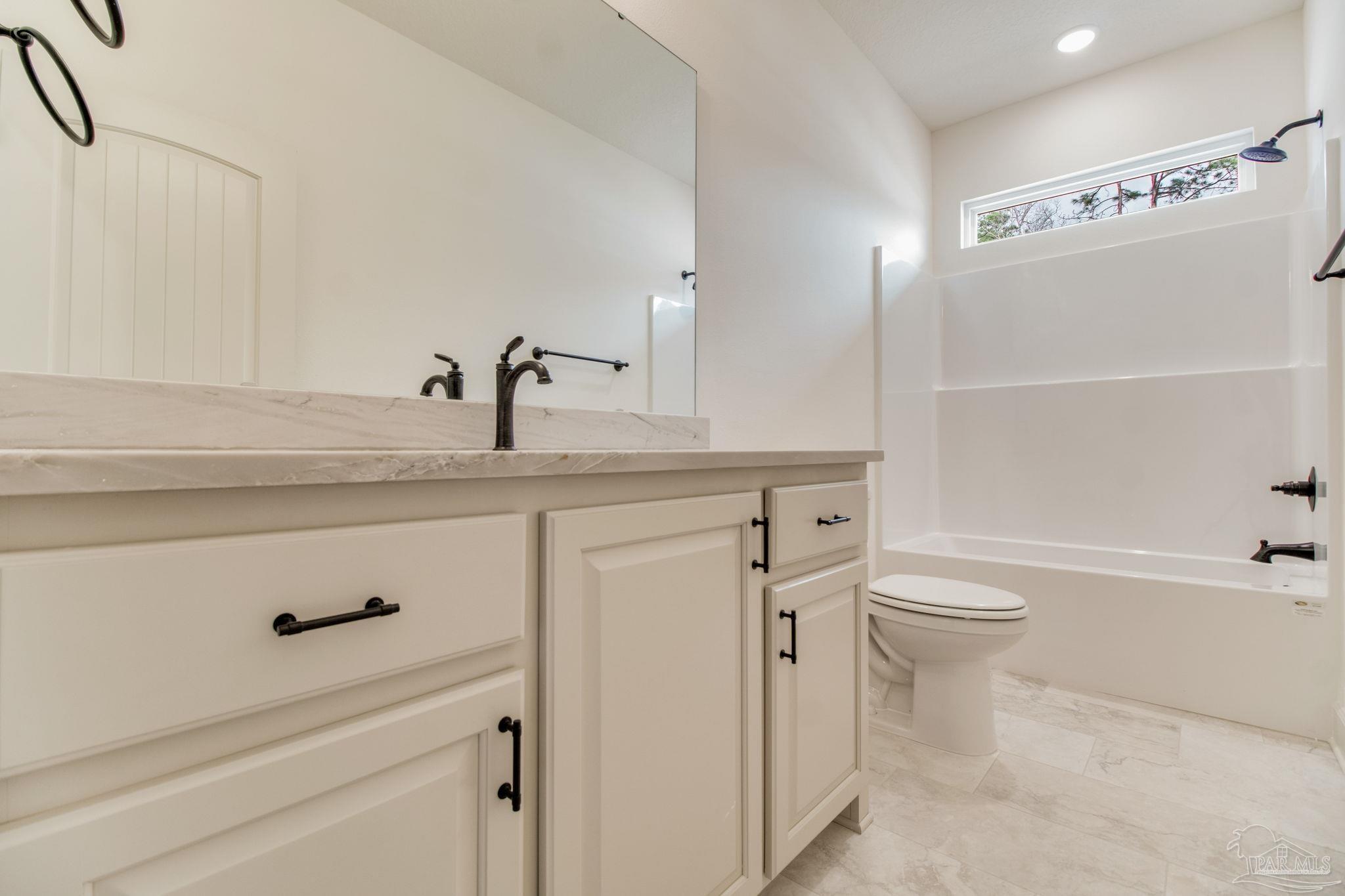 4310 Watkins Street Pace, FL 32571 - Photo 44 of 58 a bathroom with a sink a toilet and a bathtub