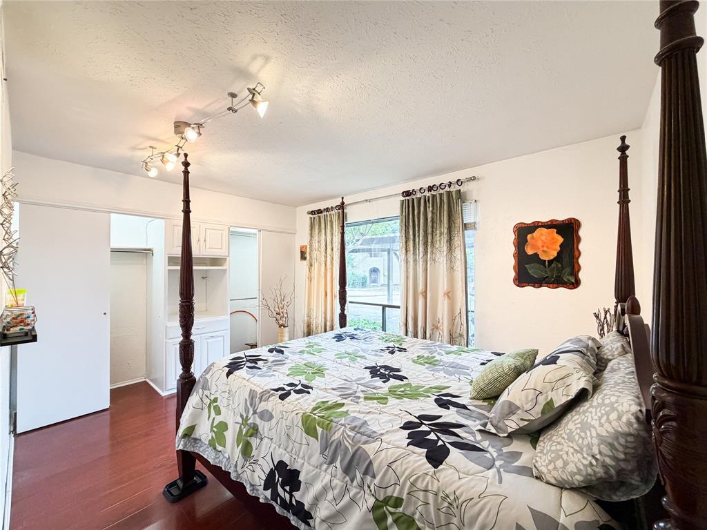 4565 North O'Connor Road, Unit 1304 Irving, TX 75062 - Photo 19 of 32 Bedroom featuring laminate flooring, track lighting, and a window