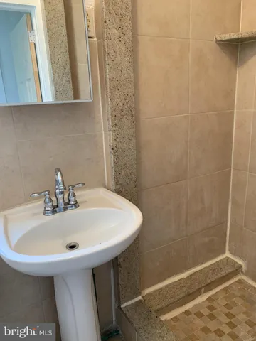 a white toilet sitting next to a white sink