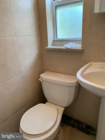 a white toilet sitting next to a bathroom sink