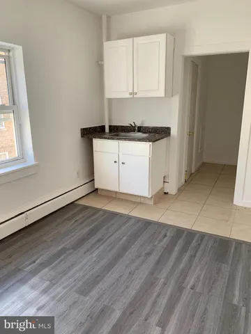 a view of a room with wooden floor and window