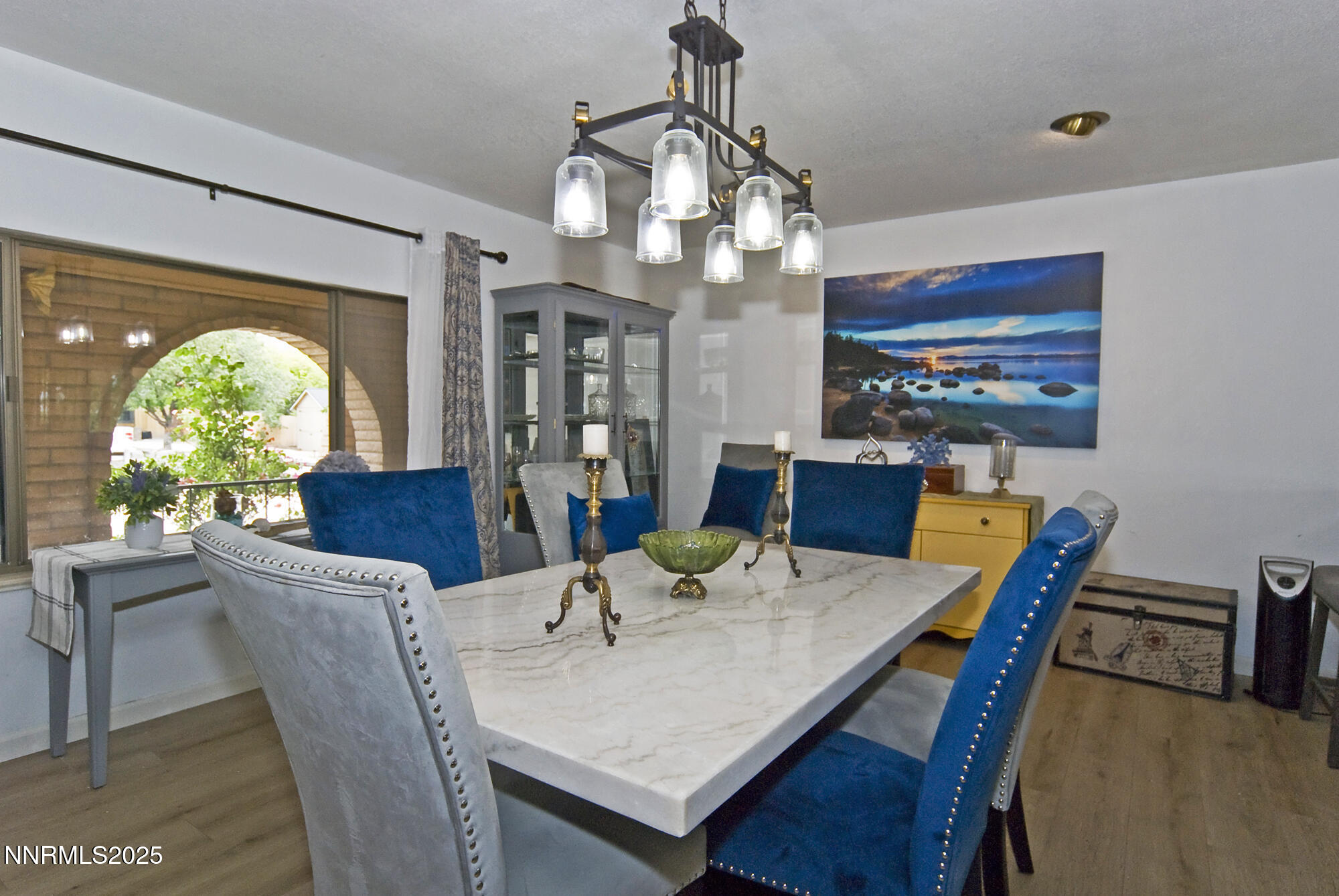 5705 Blue Hills Drive Reno, NV 89502 - Photo 13 of 56 a view of a dining room with furniture a chandelier and wooden floor