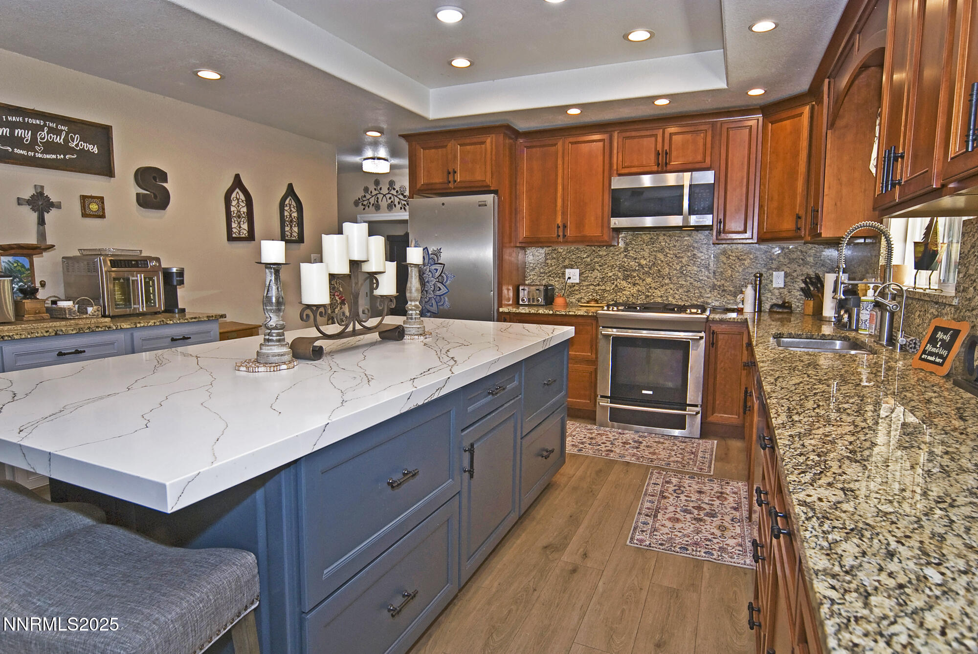 5705 Blue Hills Drive Reno, NV 89502 - Photo 17 of 56 a kitchen with stainless steel appliances granite countertop a sink stove and cabinets