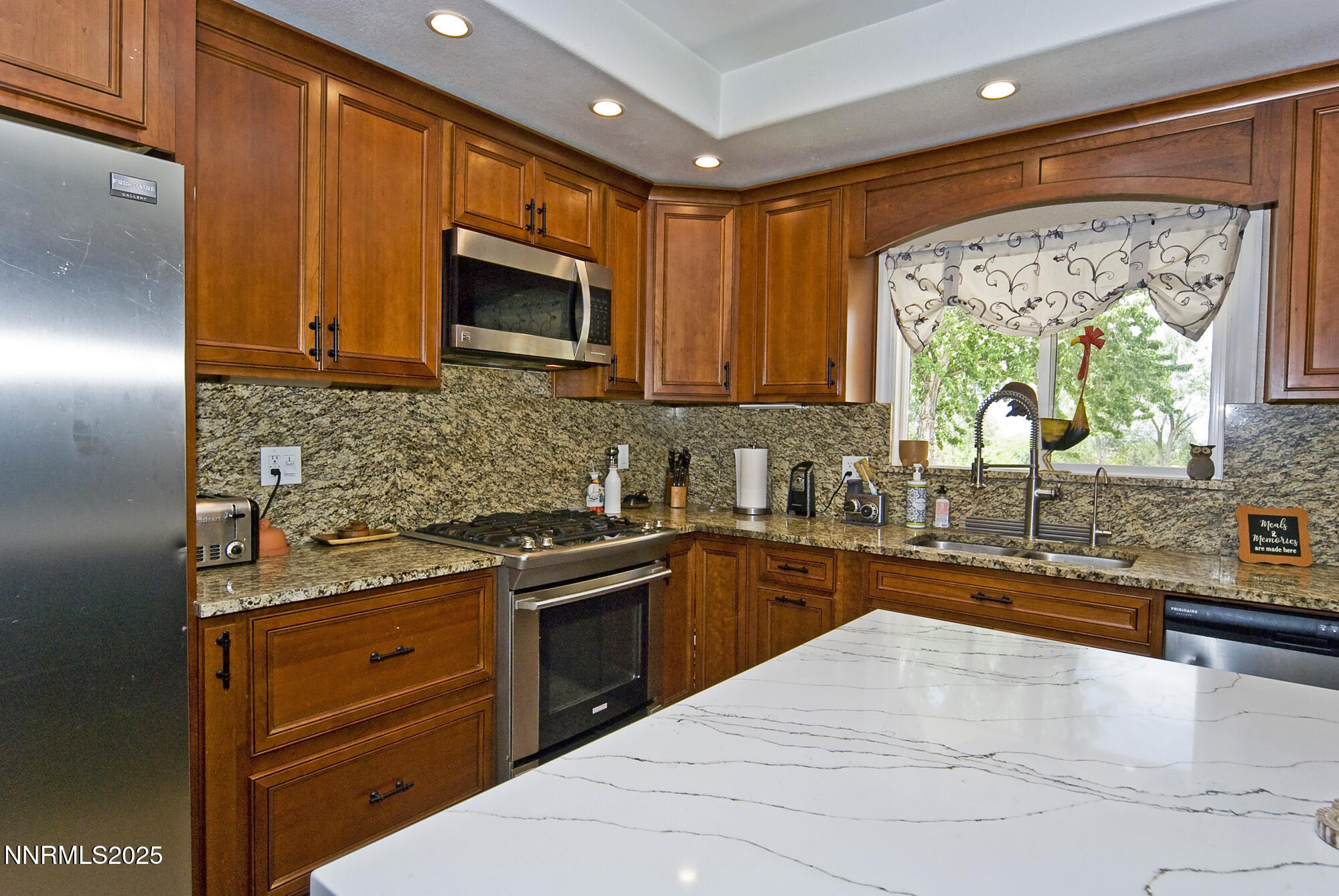 5705 Blue Hills Drive Reno, NV 89502 - Photo 18 of 56 a kitchen with stainless steel appliances granite countertop a sink stove and microwave