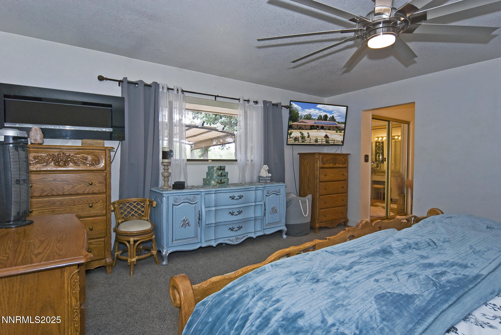 5705 Blue Hills Drive Reno, NV 89502 - Photo 26 of 56 a bedroom with a bed and a chandelier