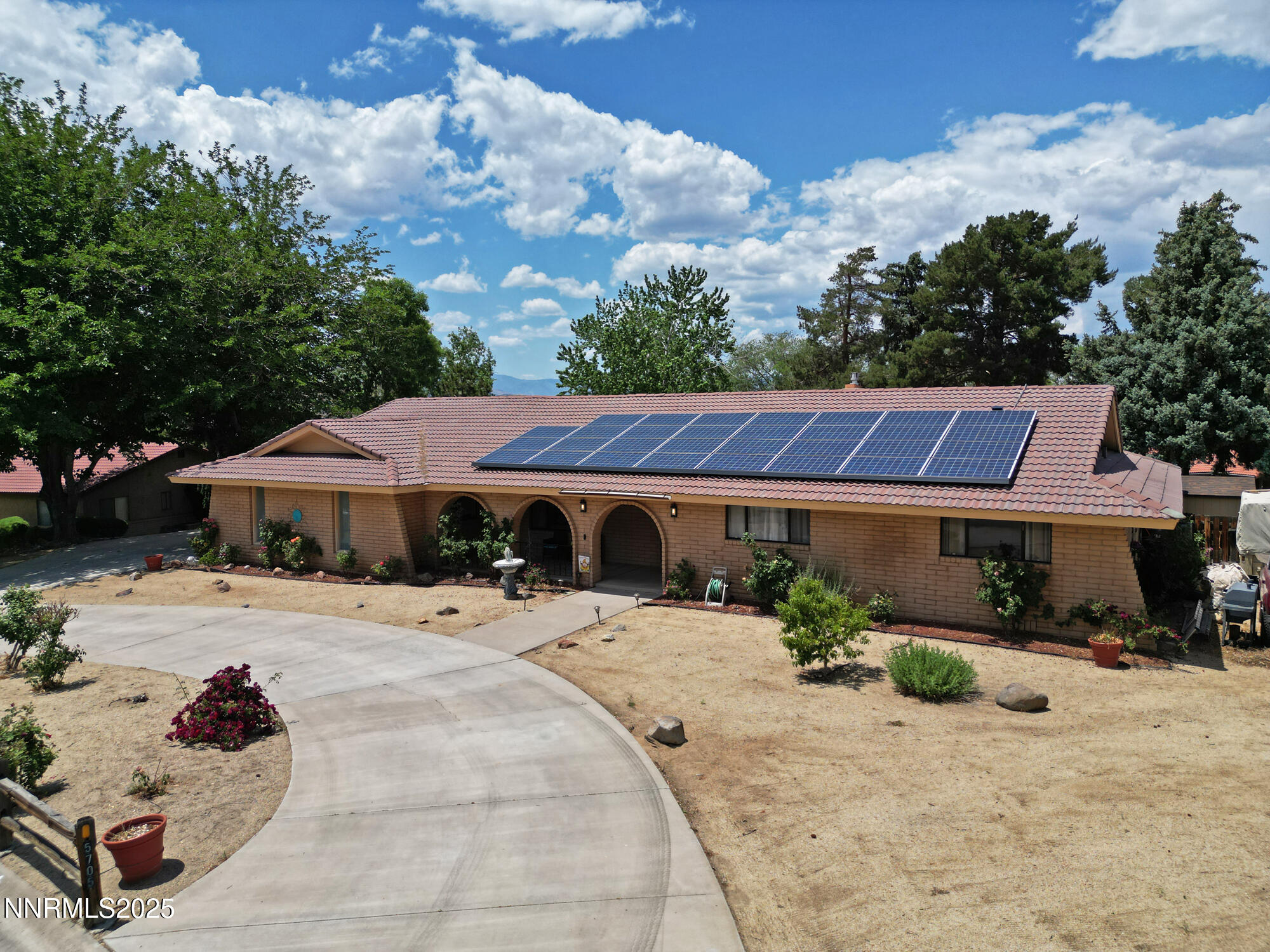 5705 Blue Hills Drive Reno, NV 89502 - Photo 47 of 56 a patio with a table and chairs under an umbrella