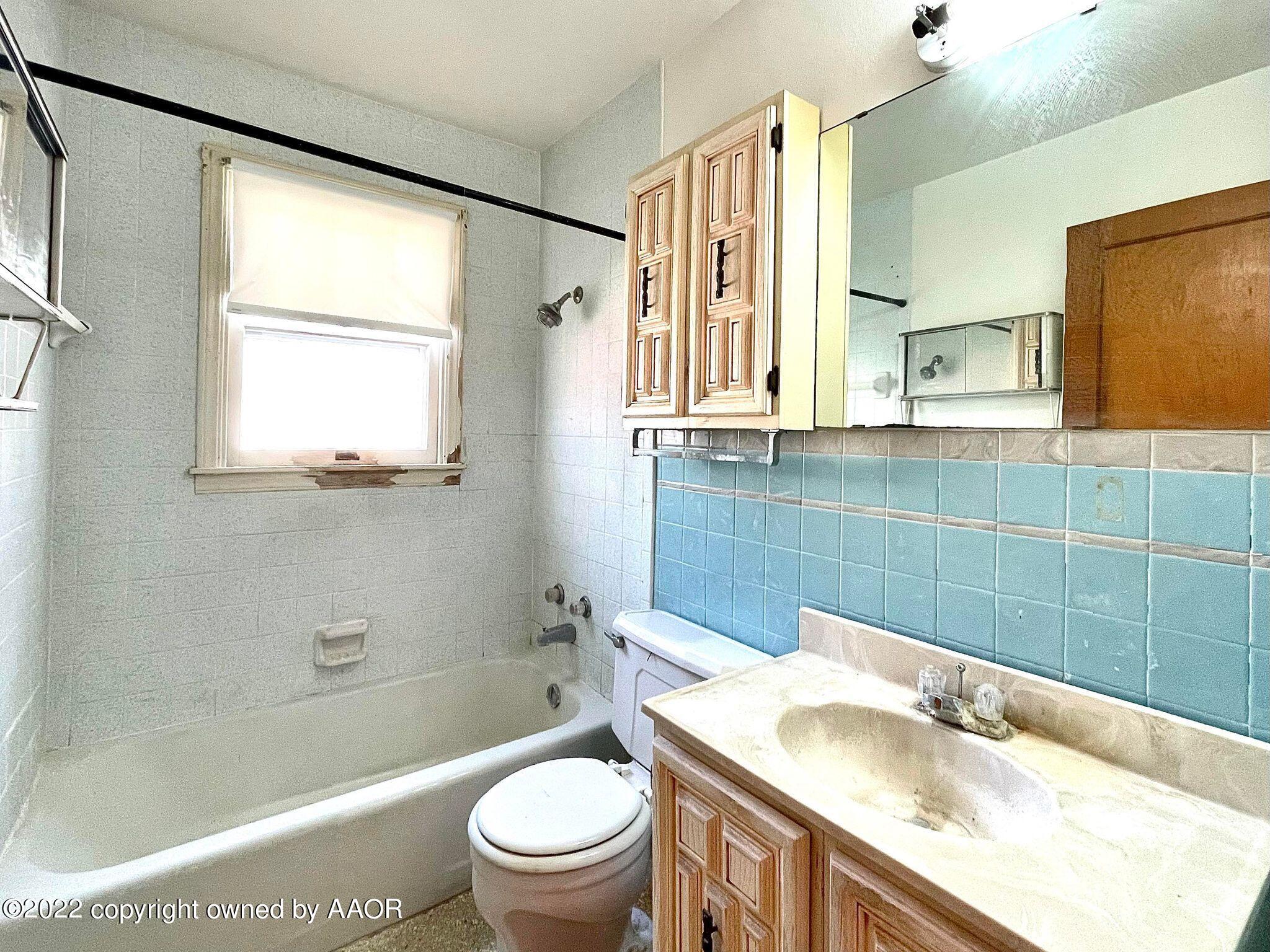 702 Sunset Terrace Amarillo, TX 79106 - Photo 11 of 21 a bathroom with a granite countertop sink toilet and shower