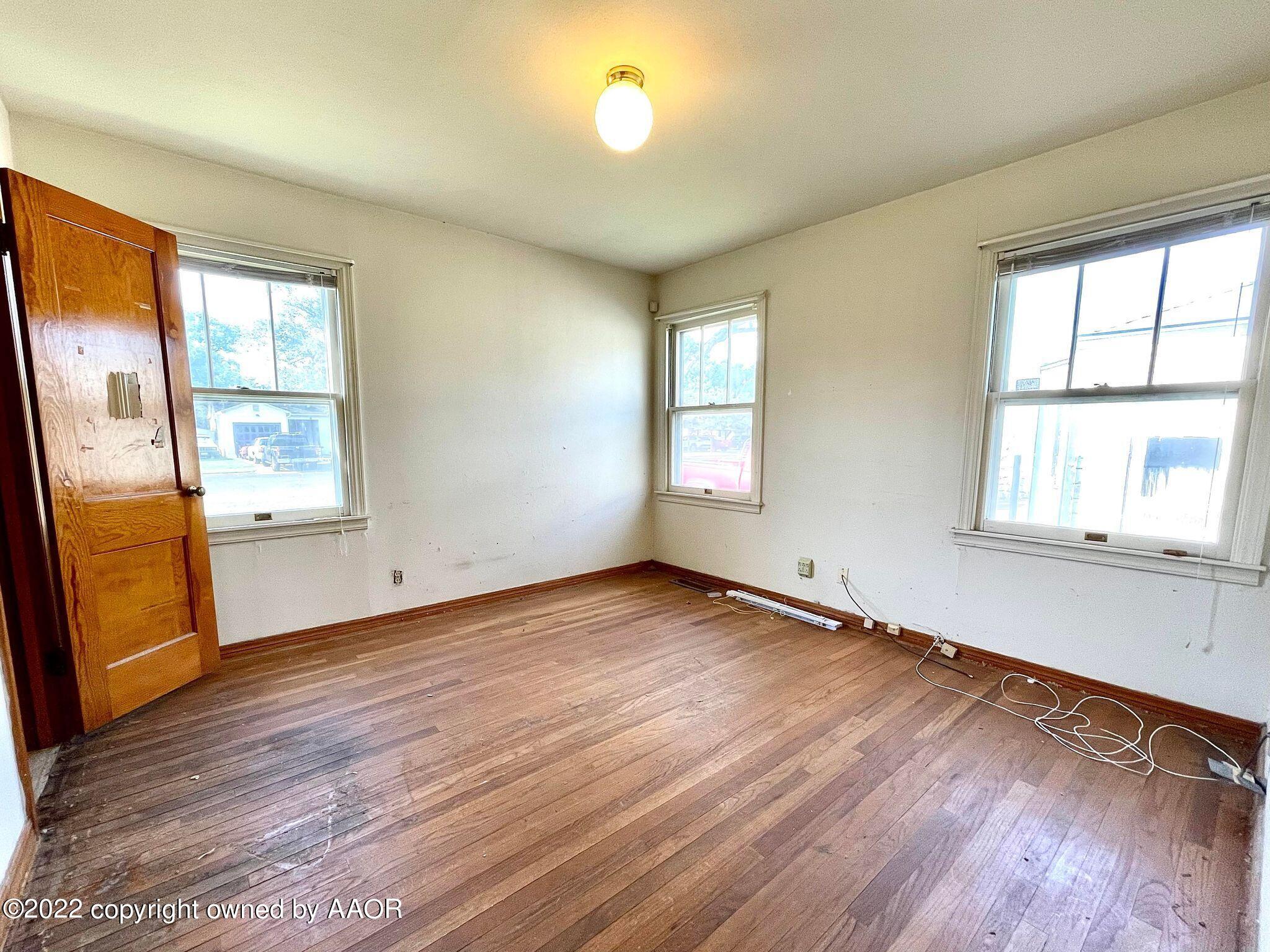 702 Sunset Terrace Amarillo, TX 79106 - Photo 12 of 21 an empty room with wooden floor and windows