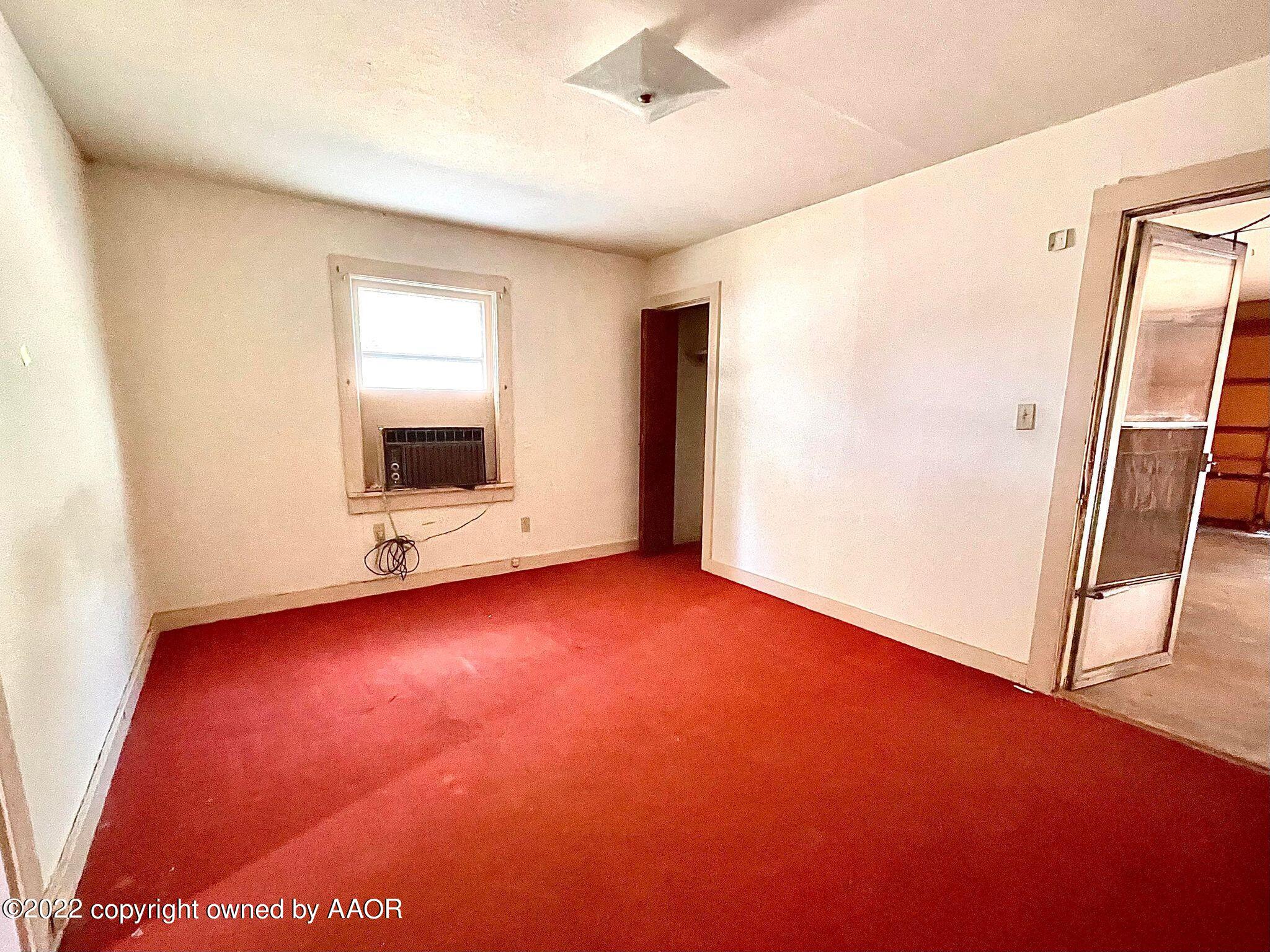 702 Sunset Terrace Amarillo, TX 79106 - Photo 19 of 21 a view of an empty room with wooden floor and a window