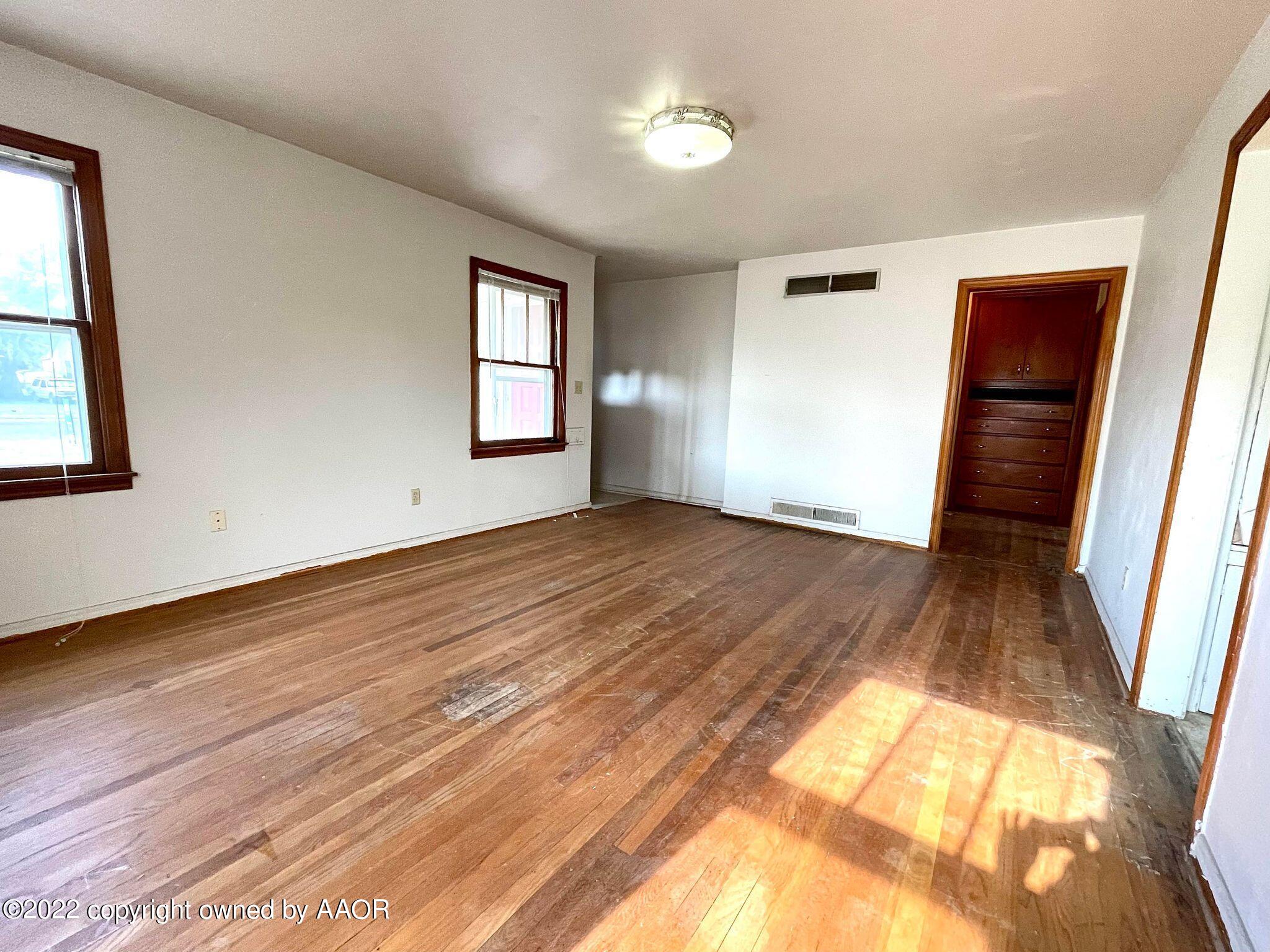 702 Sunset Terrace Amarillo, TX 79106 - Photo 5 of 21 a view of empty room with wooden floor and fan