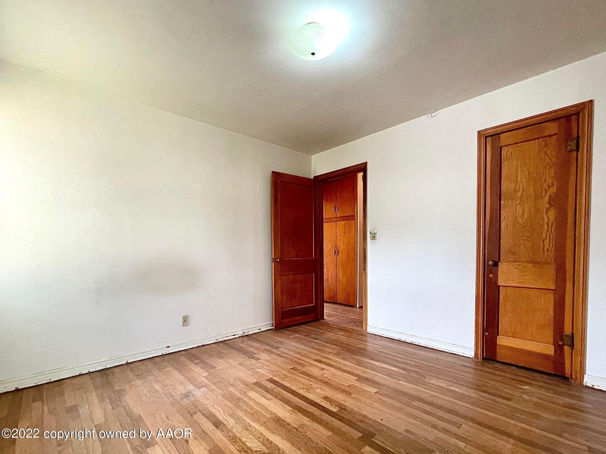 702 Sunset Terrace Amarillo, TX 79106 - Photo 9 of 21 a view of an empty room with wooden floor and a window