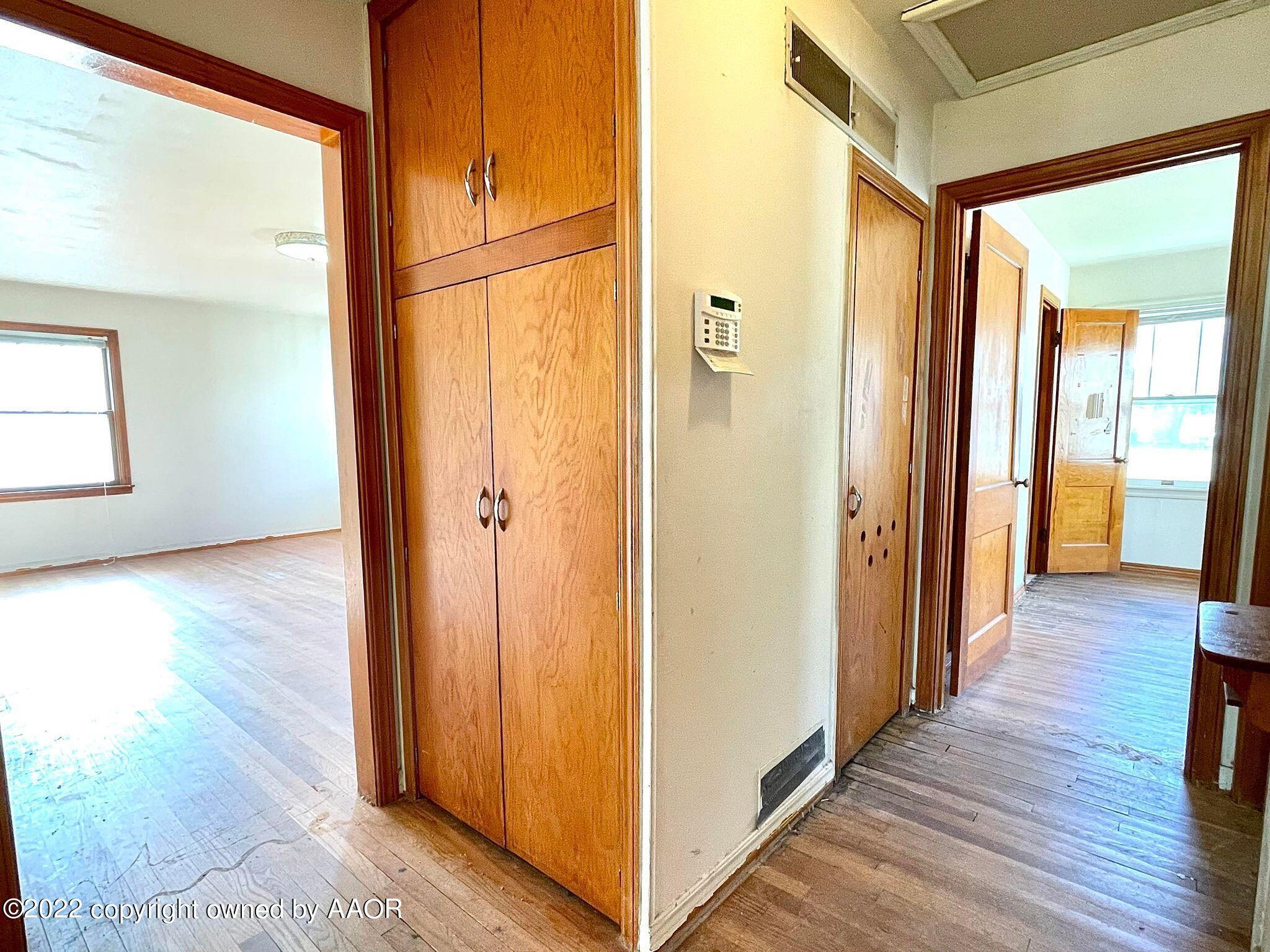 702 Sunset Terrace Amarillo, TX 79106 - Photo 10 of 21 a view of a hallway with wooden floor and staircase