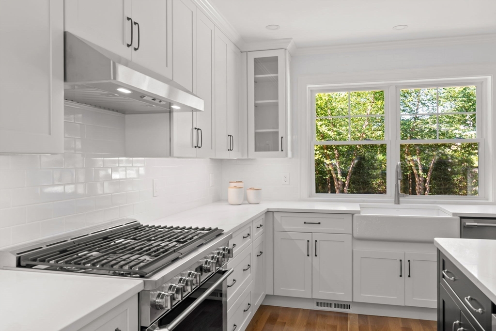 111 Killam Hill Road Boxford, MA 01921 - Photo 12 of 42 a kitchen with white cabinets and a stove top oven