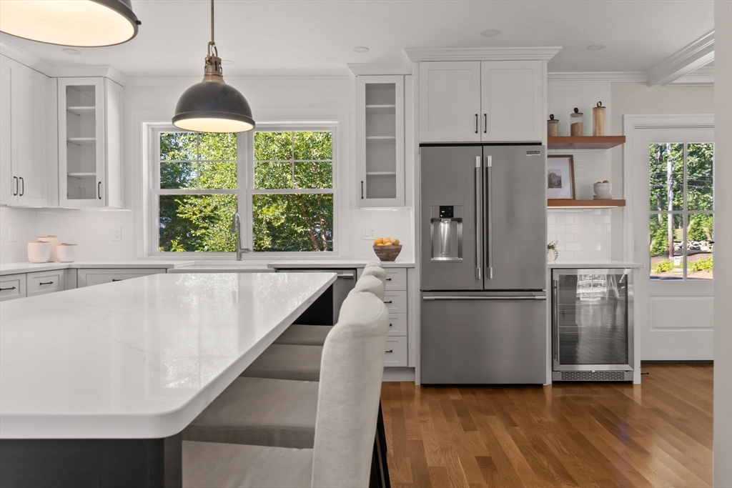 111 Killam Hill Road Boxford, MA 01921 - Photo 13 of 42 a kitchen with stainless steel appliances a refrigerator a stove a sink and a window