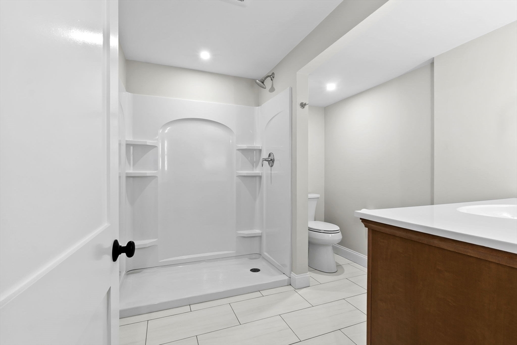 111 Killam Hill Road Boxford, MA 01921 - Photo 33 of 42 a bathroom with a granite countertop sink a toilet and shower