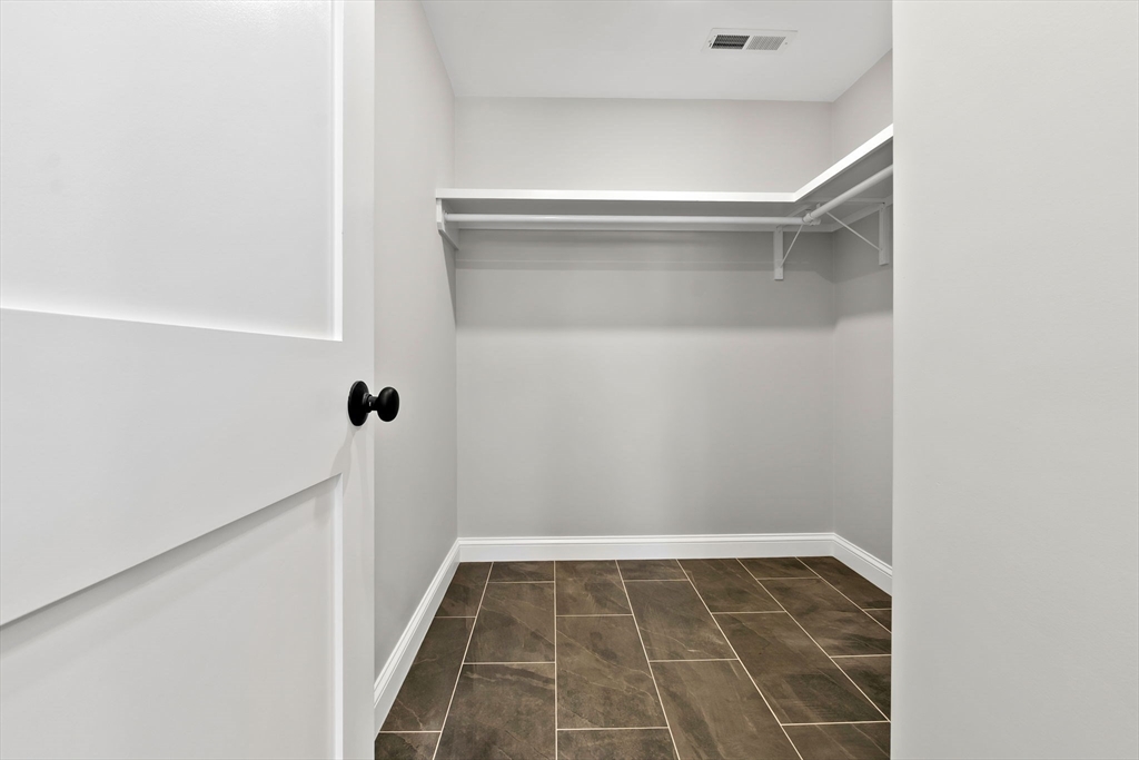 111 Killam Hill Road Boxford, MA 01921 - Photo 8 of 42 a view of a room with rack on the wall