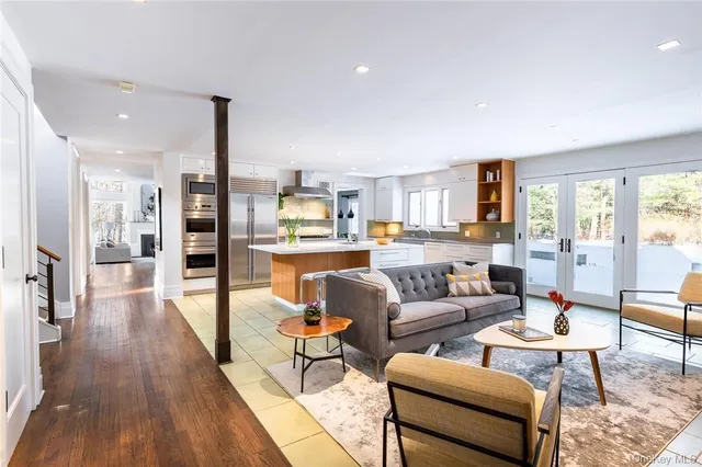 a living room with furniture wooden floor and a view of kitchen