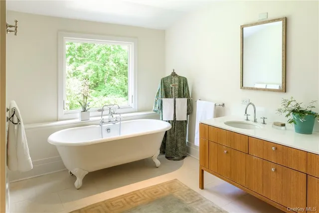 a spacious bathroom with a double vanity sink and a bathtub