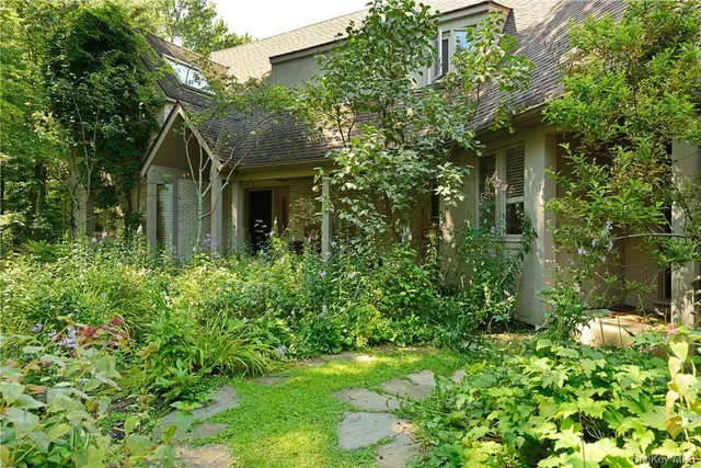 a front view of a house with garden