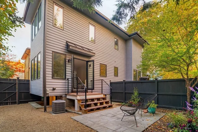 a view of a chairs in the back yard of the house