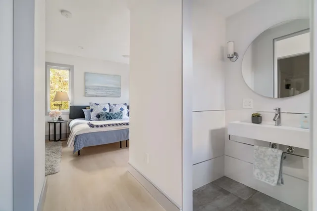 a bathroom with a bathtub sink and mirror