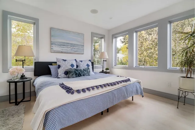 a bed sitting in a bedroom next to a window