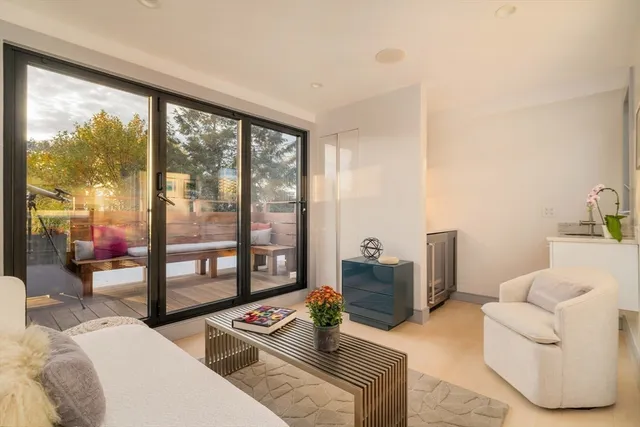 a living room with furniture and floor to ceiling windows