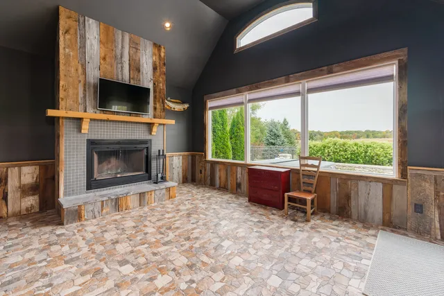 a living room with furniture a flat screen tv and a fireplace