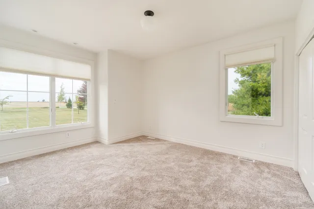 an empty room with large windows