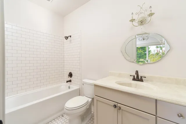a bathroom with a sink a toilet and bathtub