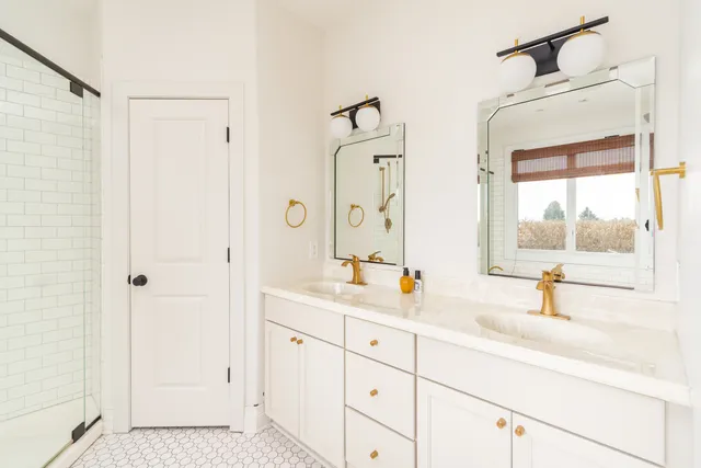 a bathroom with a double vanity sink mirror and