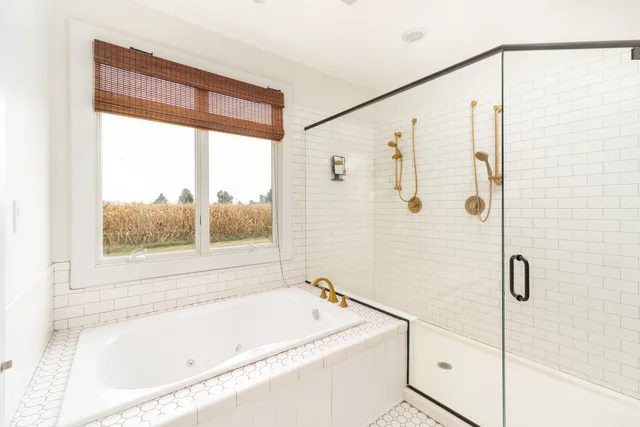a bathroom with a bathtub and a shower