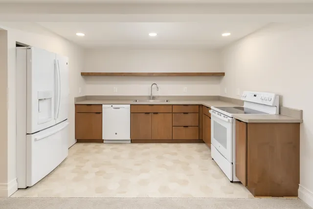 a kitchen with a sink stove and refrigerator