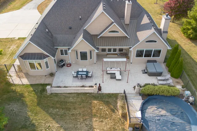 a aerial view of a house with a yard and lake view