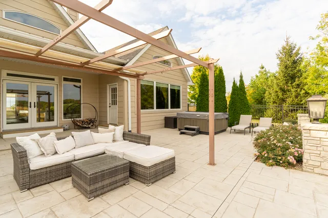 a view of a patio with dining table and chairs with wooden floor